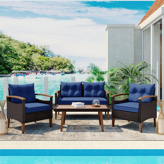 Wicker outdoor patio furniture set with blue cushions on a deck