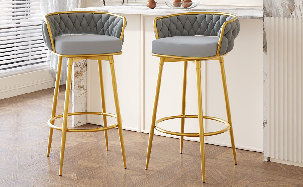 Gray upholstered bar stool with diamond tufting and gold metal legs