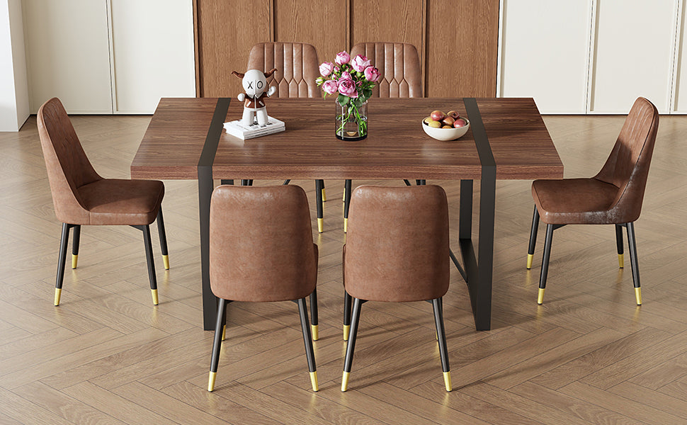 Brown upholstered dining chairs with goldtipped black legs around a dark wood table