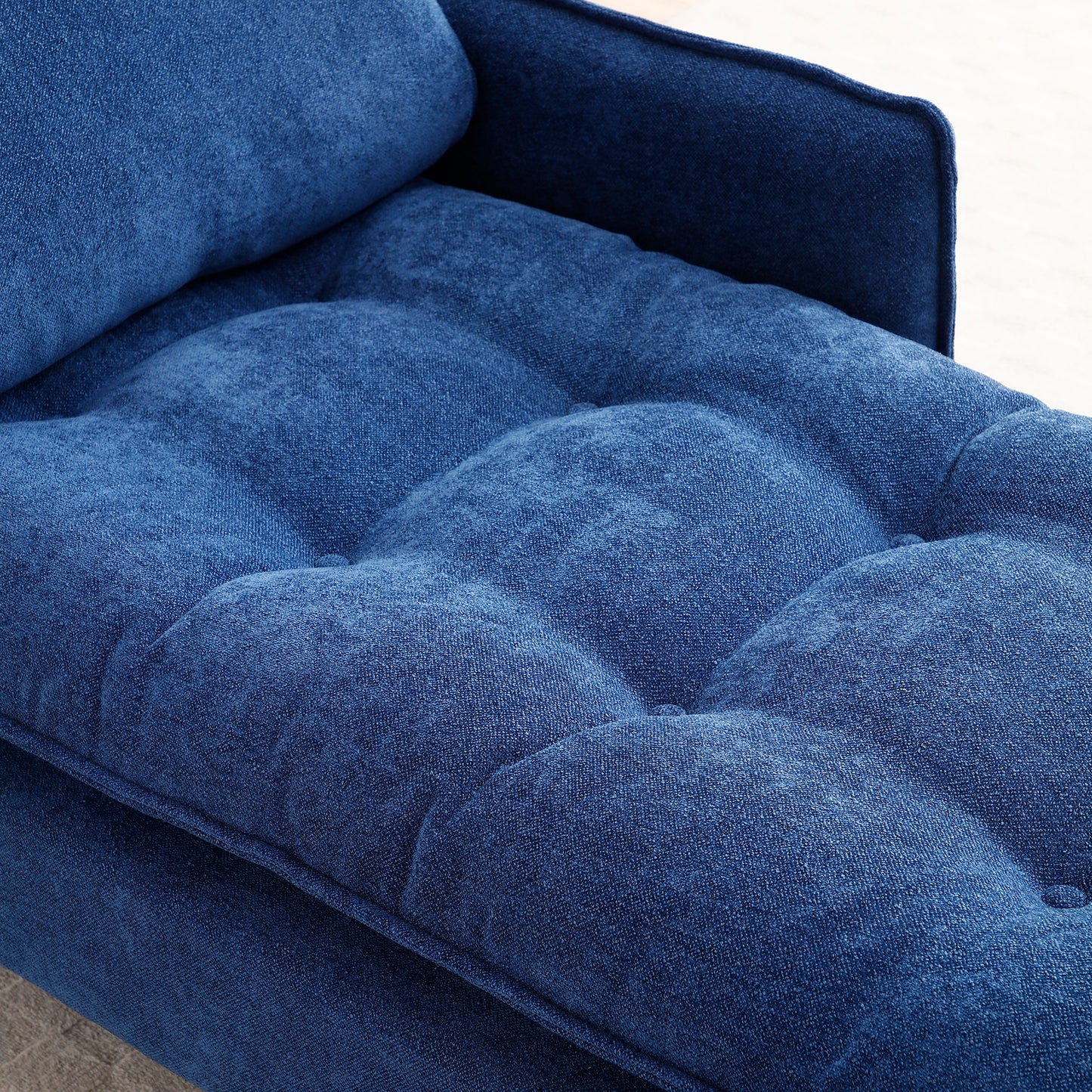 Deep blue tufted sofa cushion with textured fabric