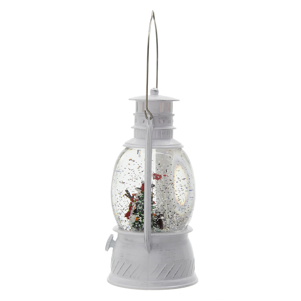 White vintage lantern snow globe with miniature Christmas tree and Santa figurine
