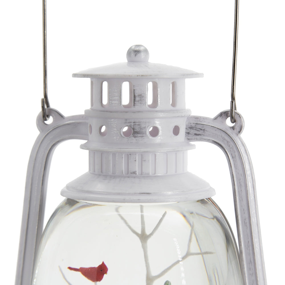 White distressed metal lantern with cardinal inside glass globe hanging hook