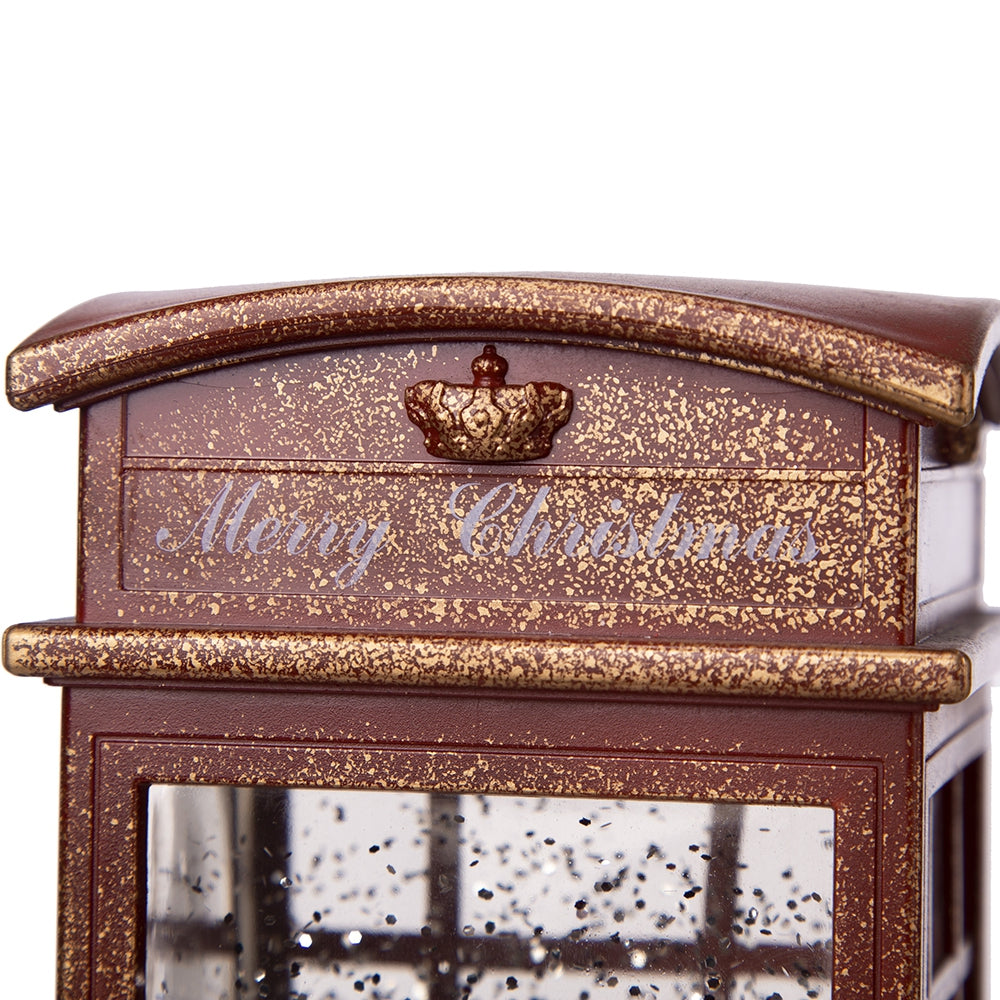 Ornate brown Christmas snow globe with crown detail and Merry Christmas text