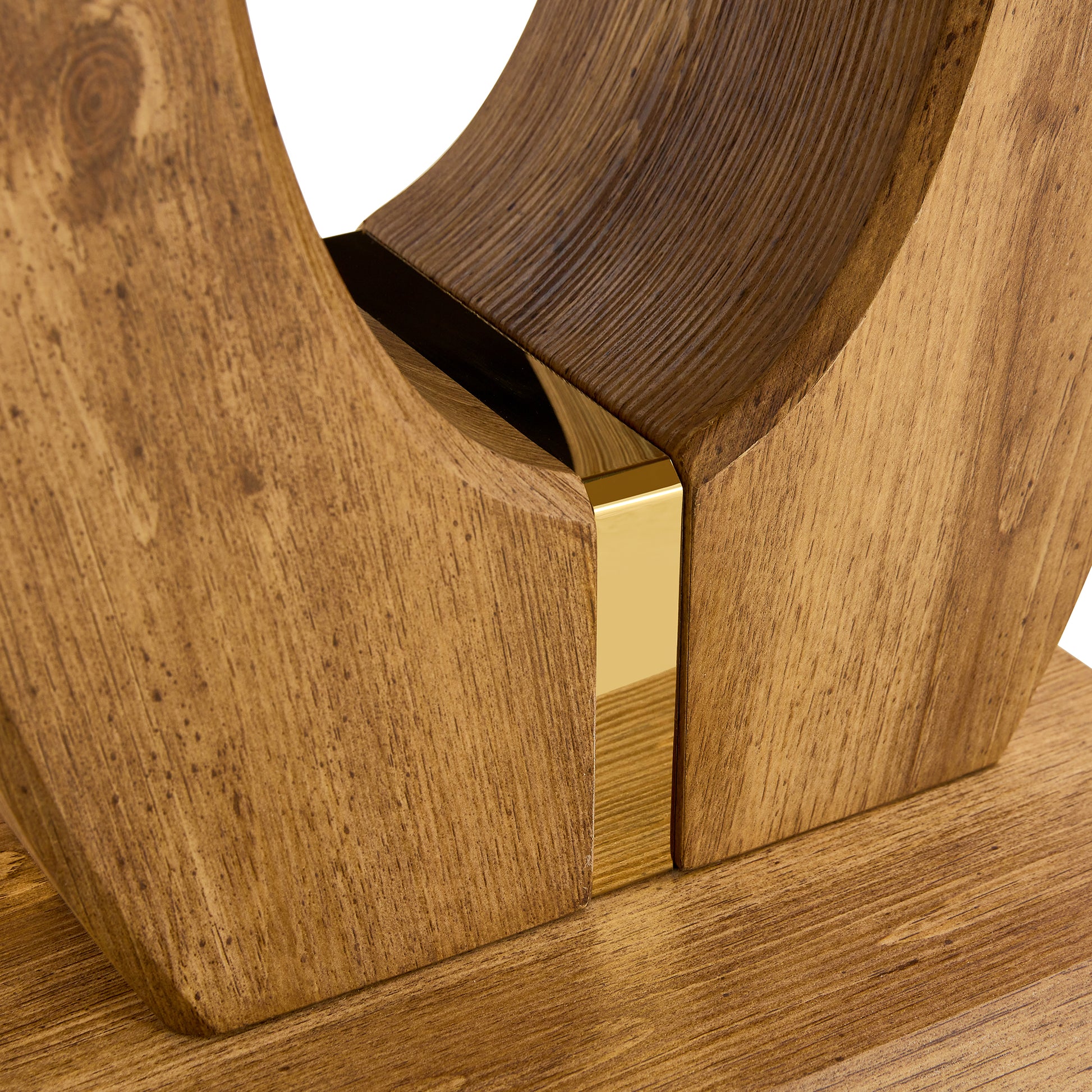 Closeup of natural wood grain sculpture with gold accents