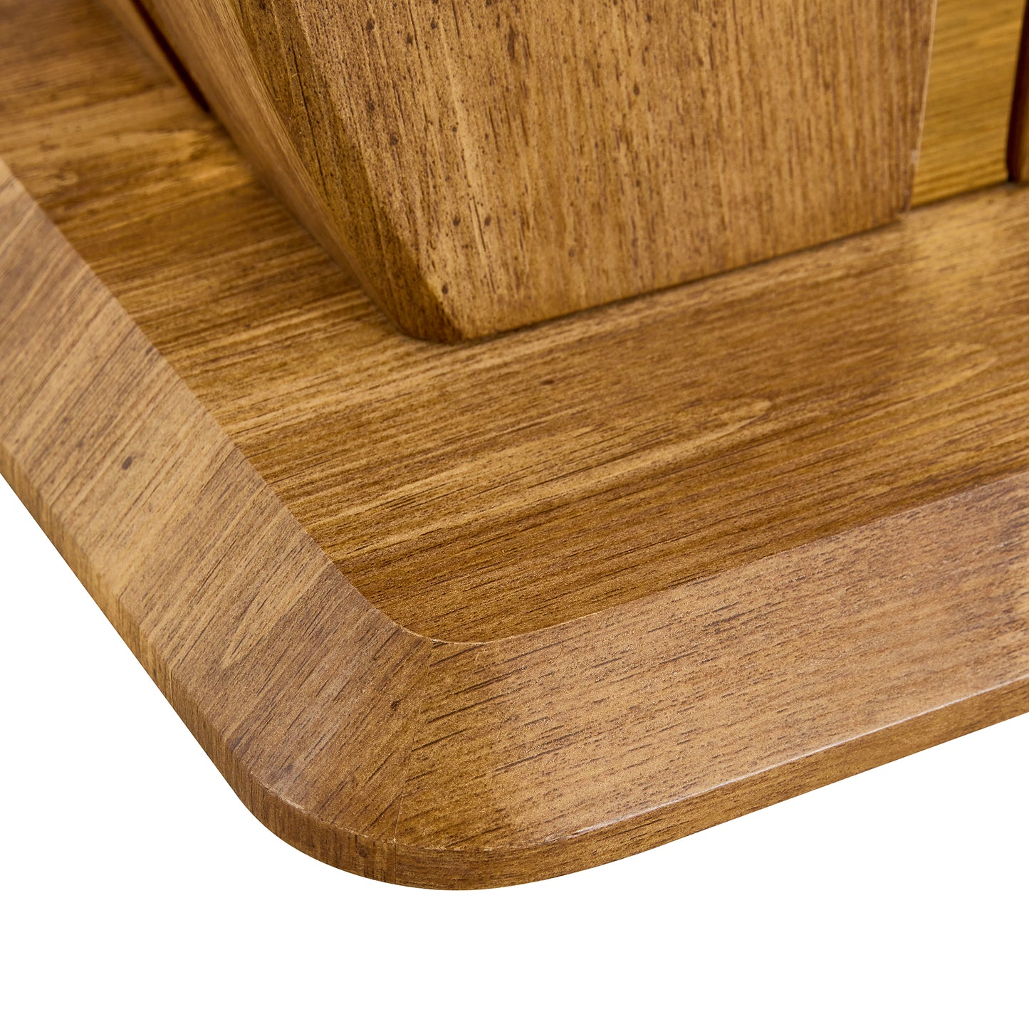 Closeup of a dark woodgrain veneer table edge with a rounded corner