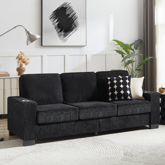 Black corduroy sofa with plush cushions and integrated cup holders