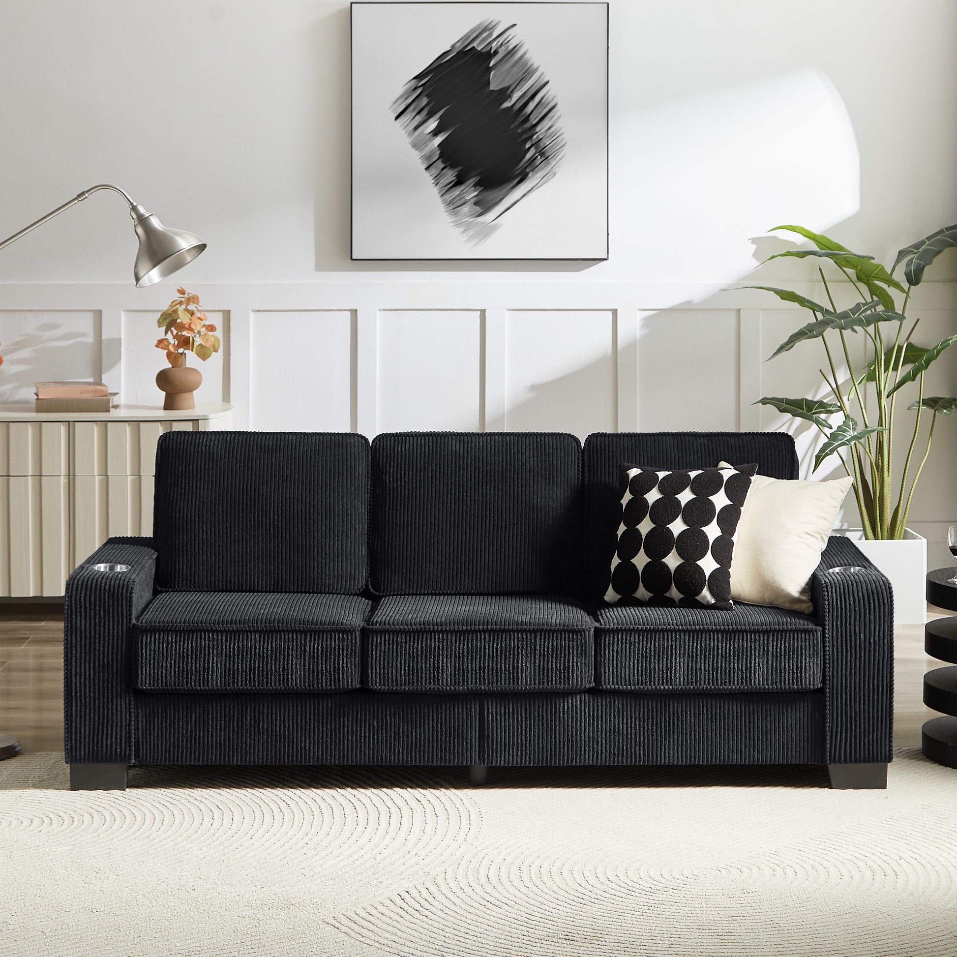 Black corduroy sofa with builtin cup holders for modern living rooms