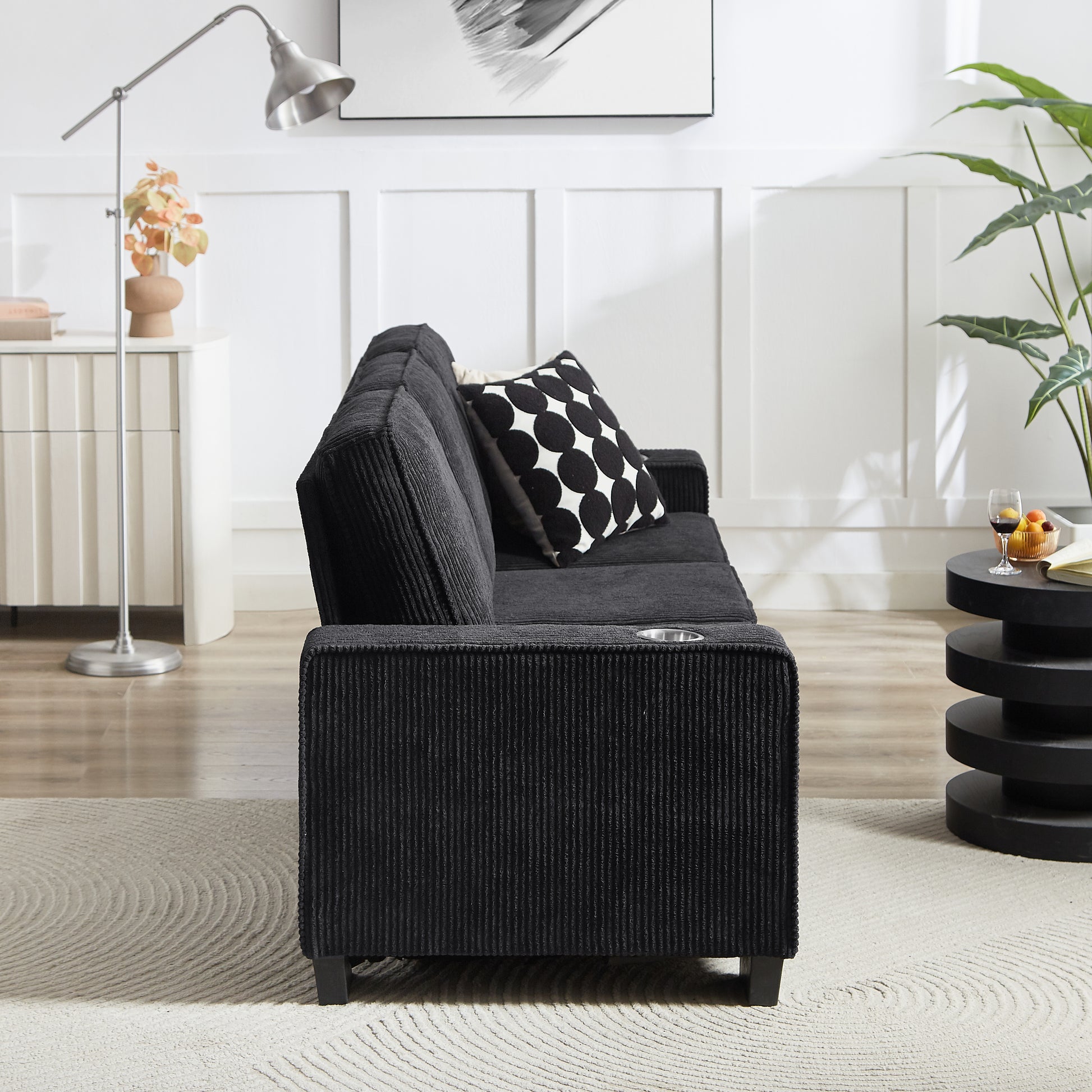 Black corduroy sofa with modern design and builtin cup holder