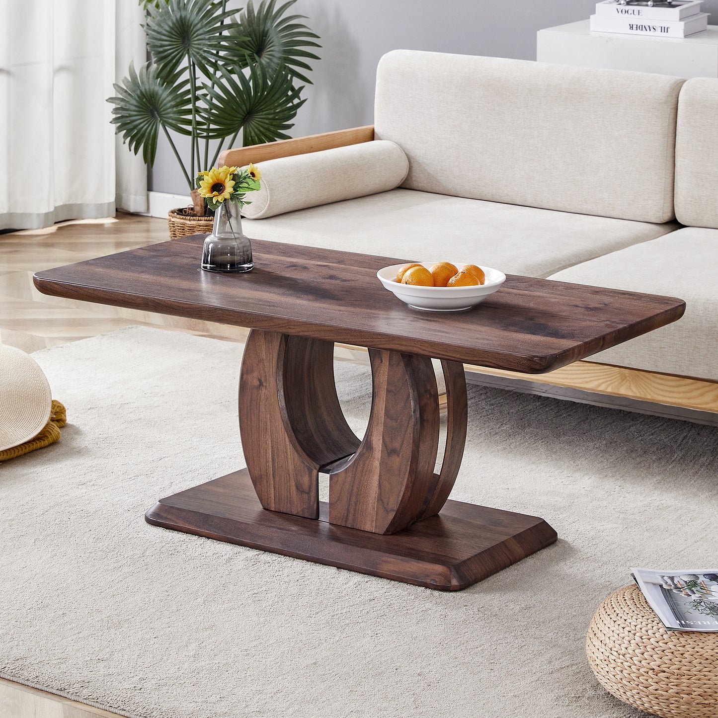Dark wood oval coffee table with curved pedestal base