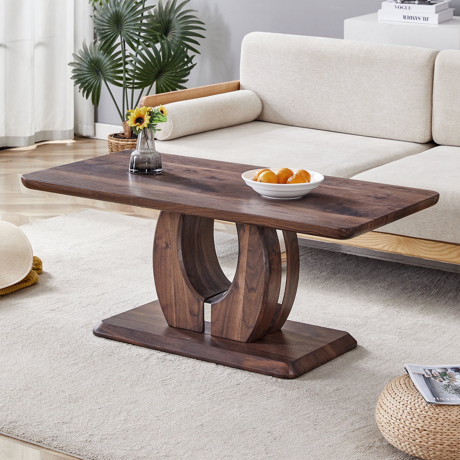 Dark wood oval coffee table with curved pedestal base