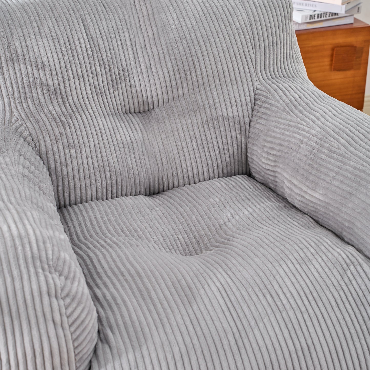 Closeup of a plush grey corduroy sofa cushion