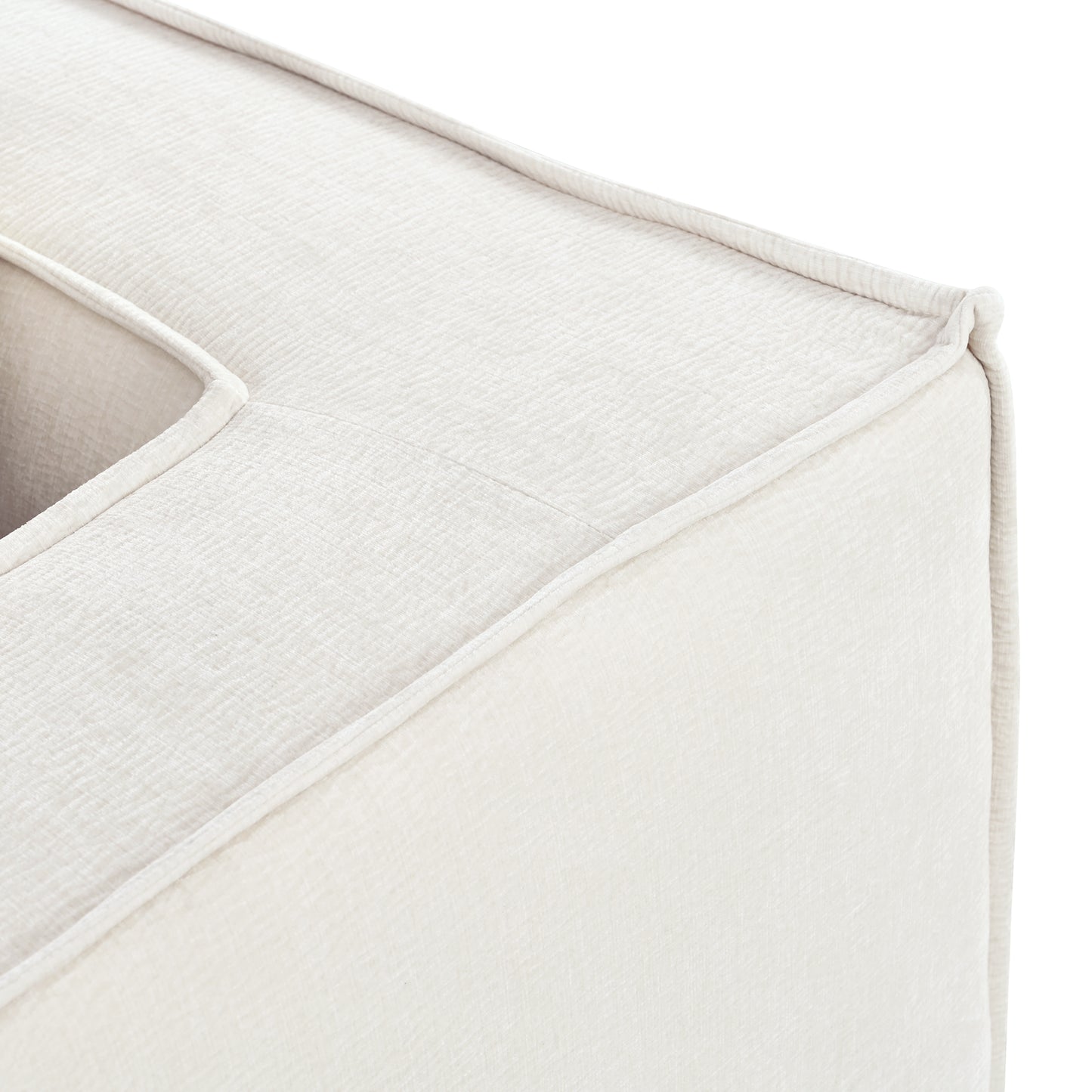 Closeup of textured cream boucle fabric on a modern armchair