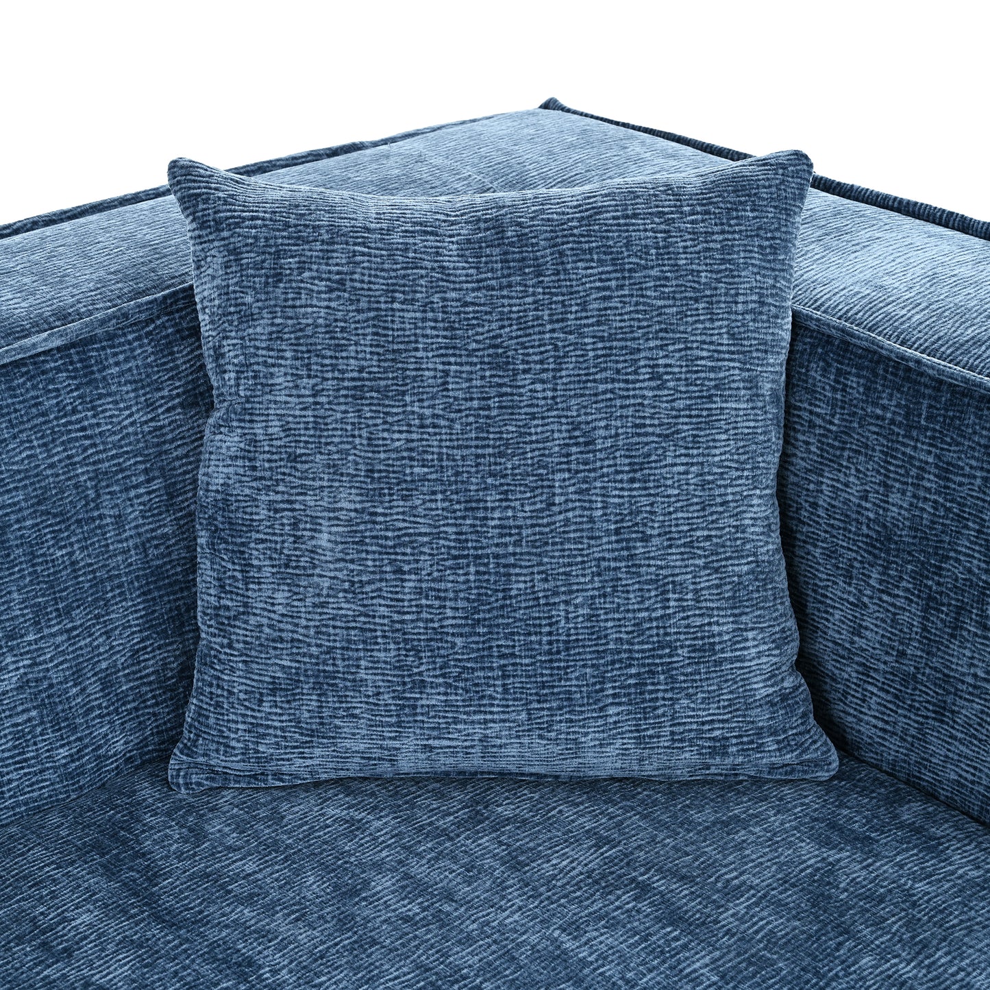 Textured blue velvet pillow on a matching sofa