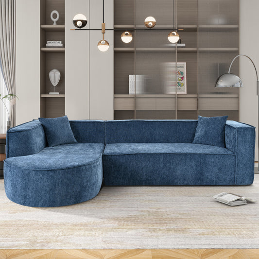 Blue fabric sectional sofa with curved chaise lounge and matching throw pillows