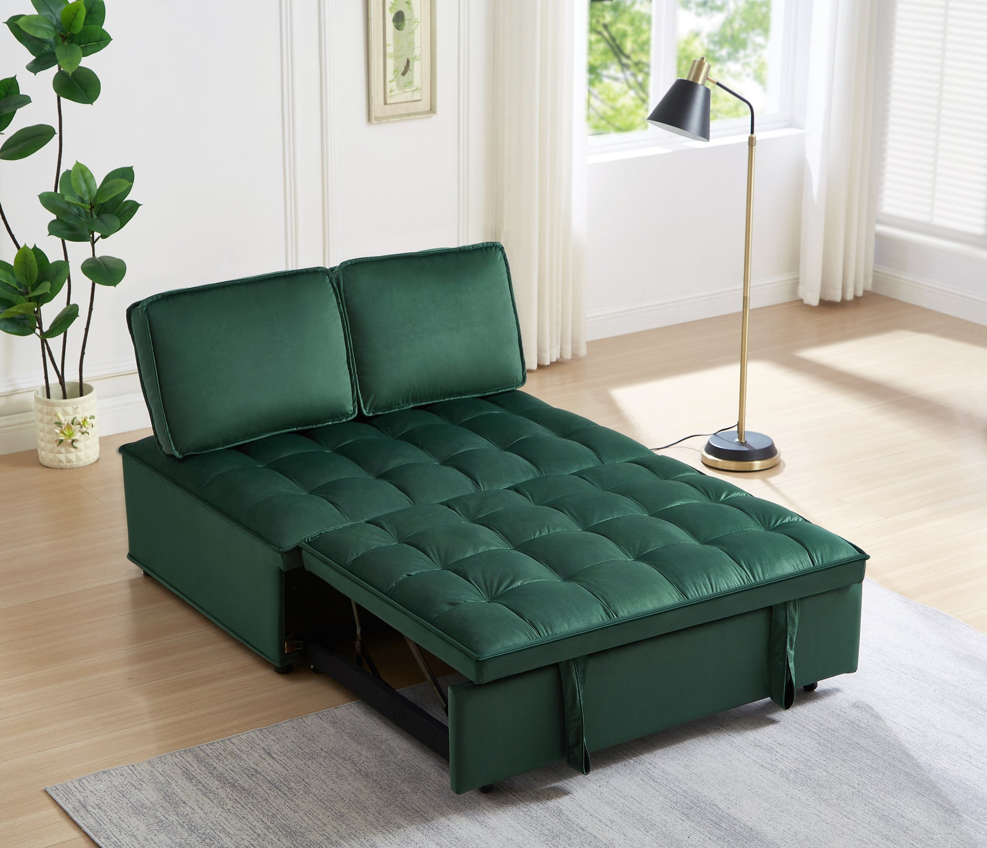 Green velvet sofa bed with tufted cushions and pullout mattress