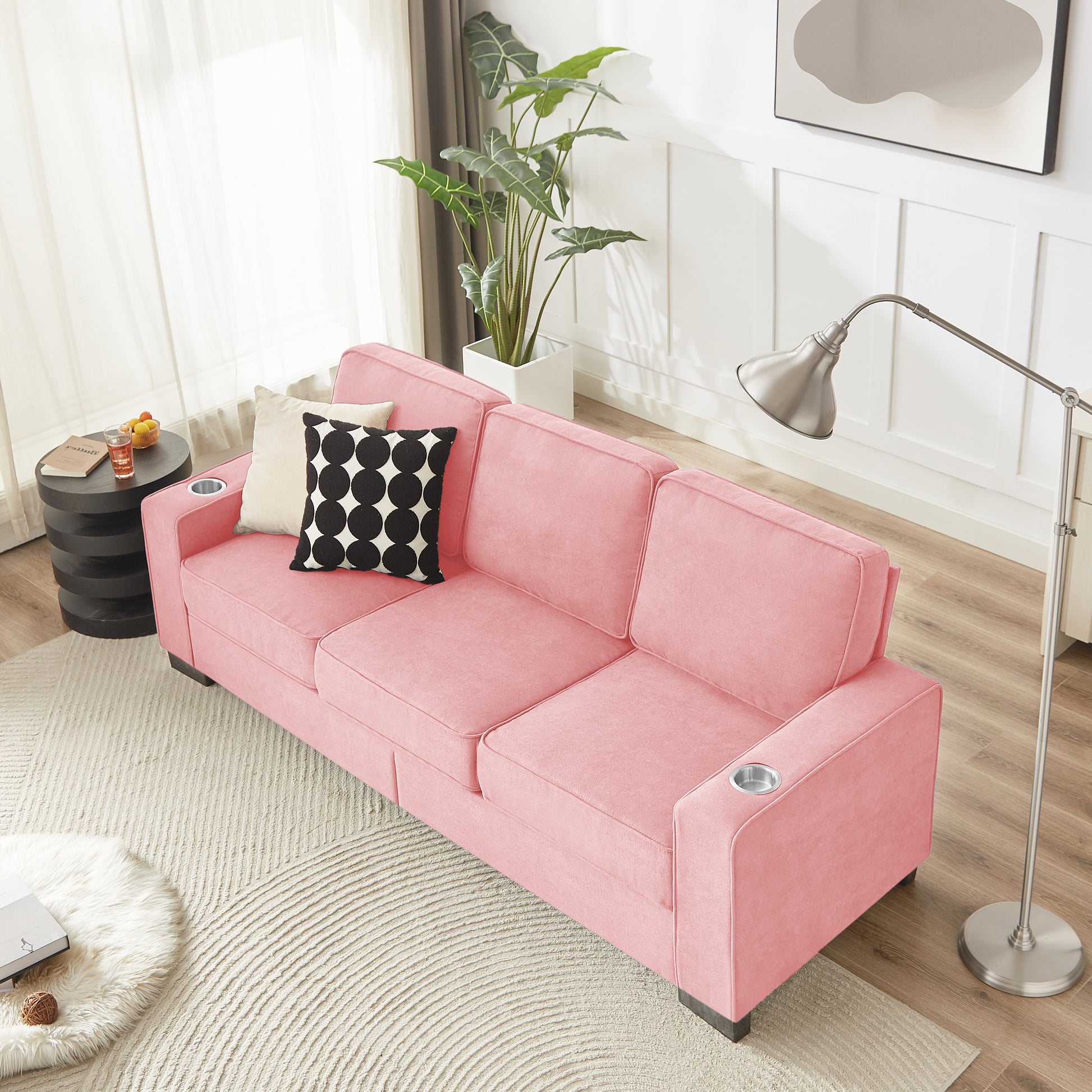 Pink velvet threeseater sofa with builtin cup holders