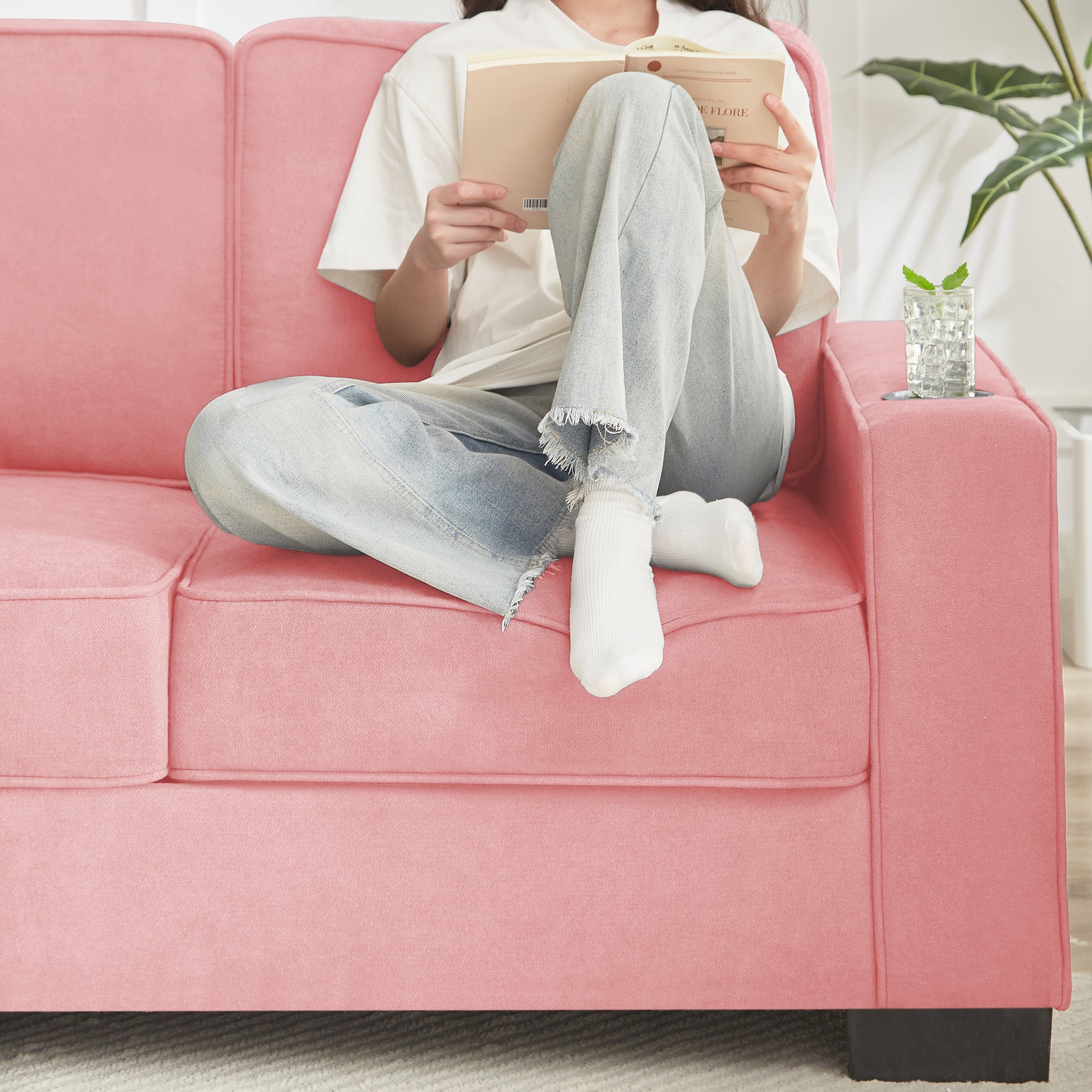 Pink velvet loveseat with plush cushions