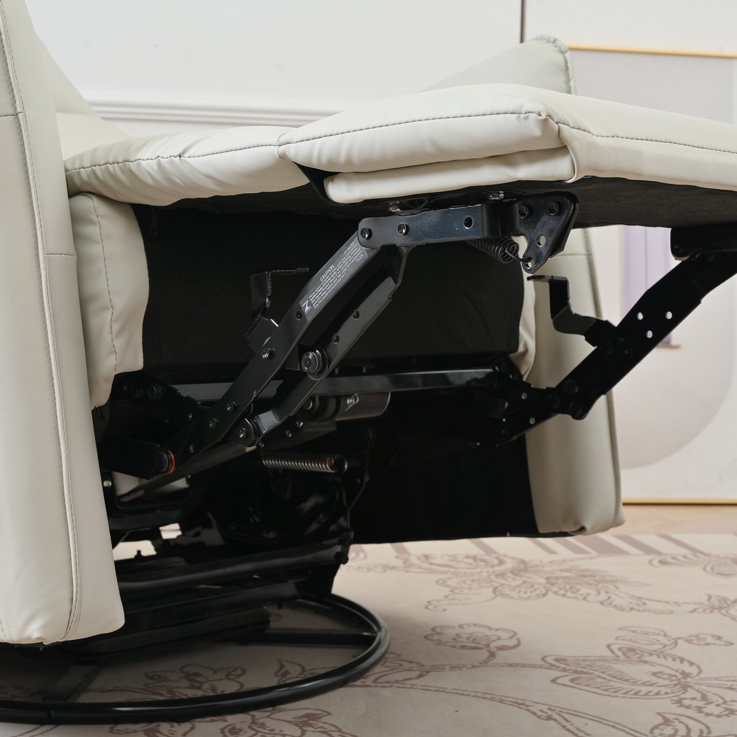 Cream faux leather recliner mechanism closeup