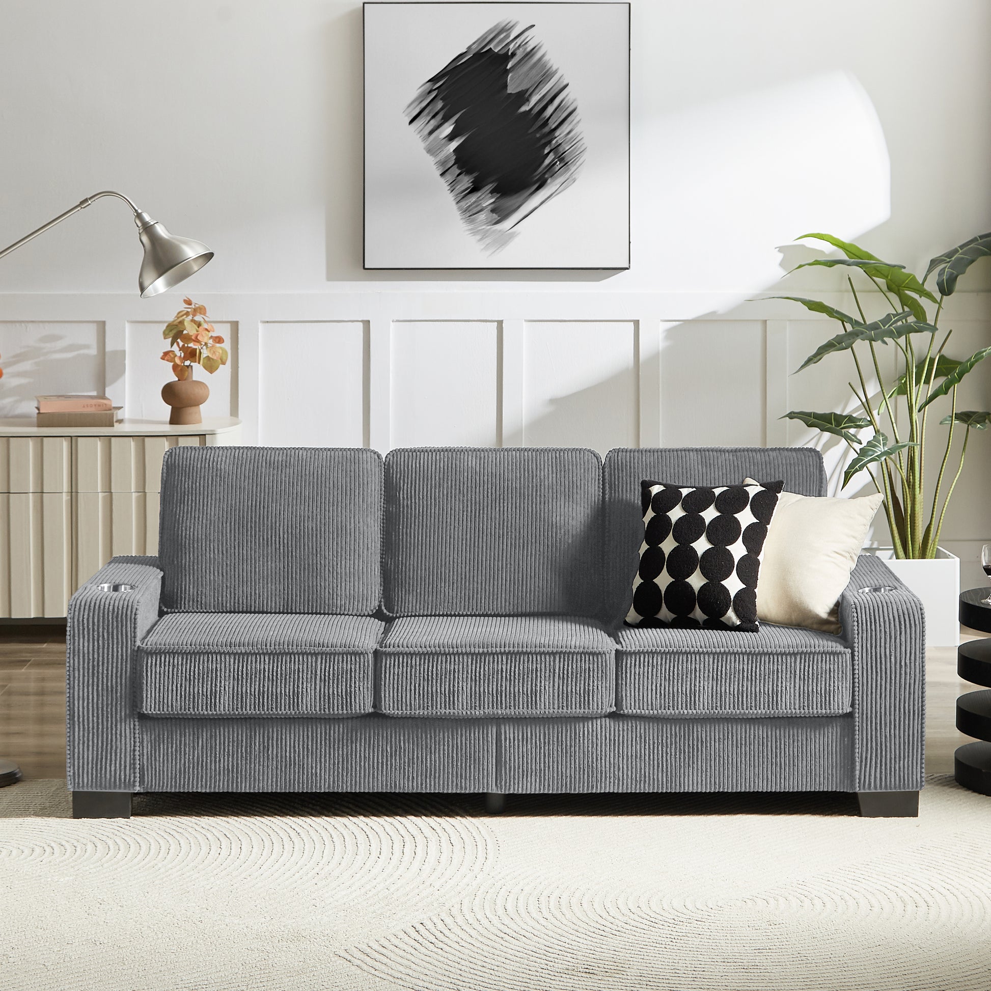 Gray corduroy sofa with cupholders on armrests