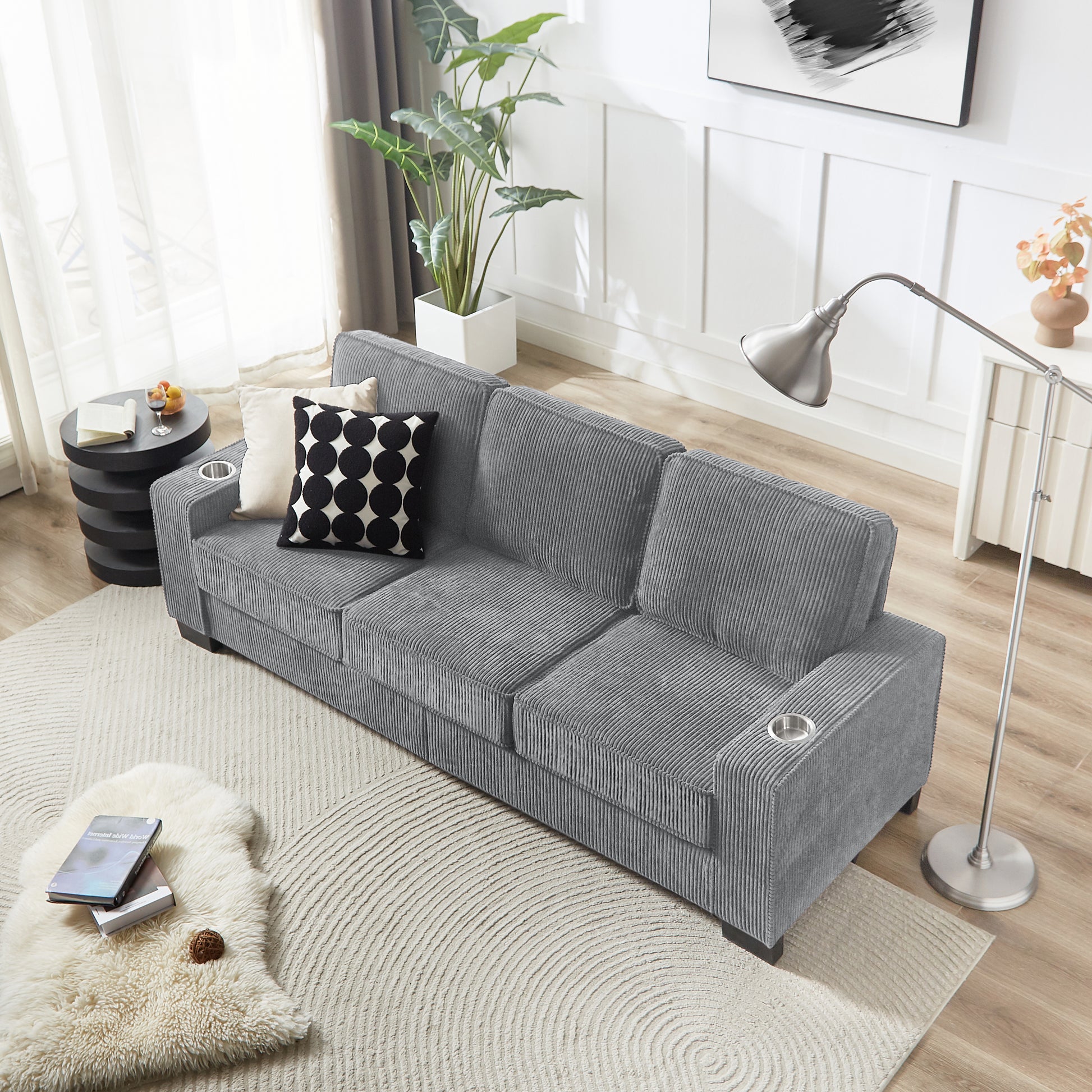 Gray corduroy sofa with builtin cup holders for modern living room comfort