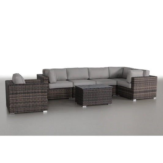 Wicker sectional outdoor sofa with grey cushions and dark wood coffee table