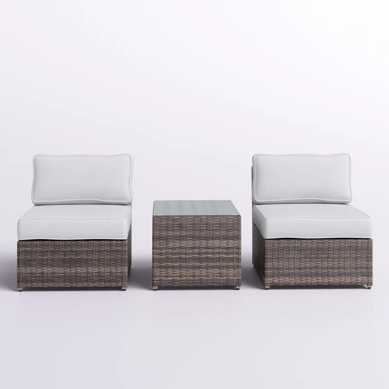 Brown wicker armless chair with white cushion