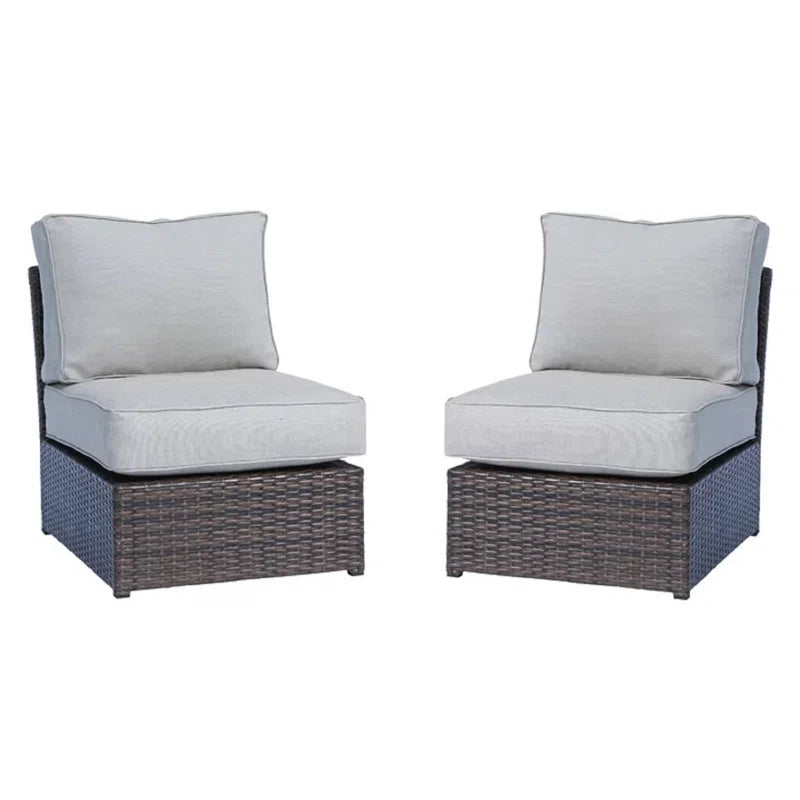 Wicker armless outdoor chair with plush light gray cushions