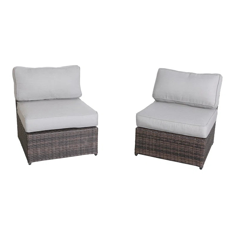 Two grey upholstered armless outdoor chairs with brown wicker bases