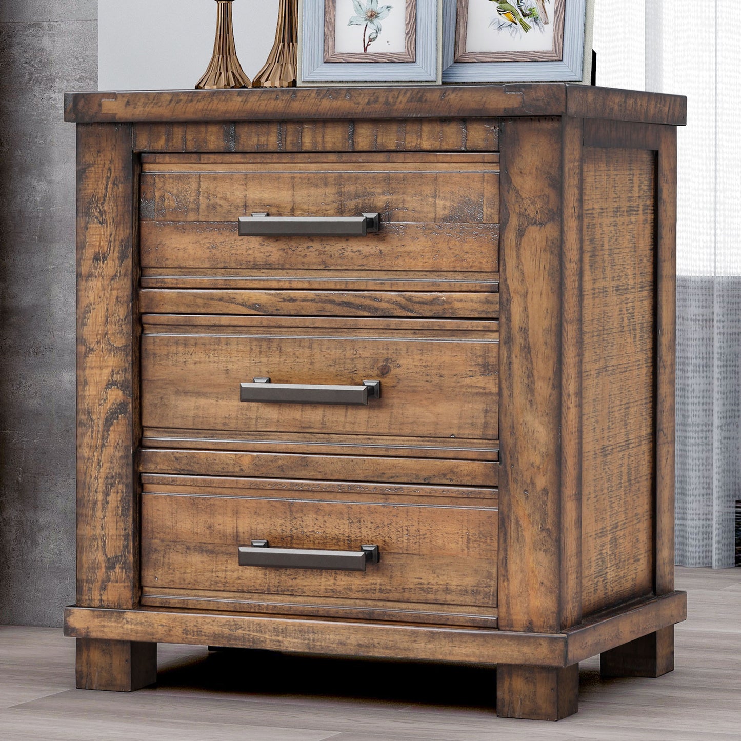 Rustic pine wood nightstand with three drawers and dark metal pulls