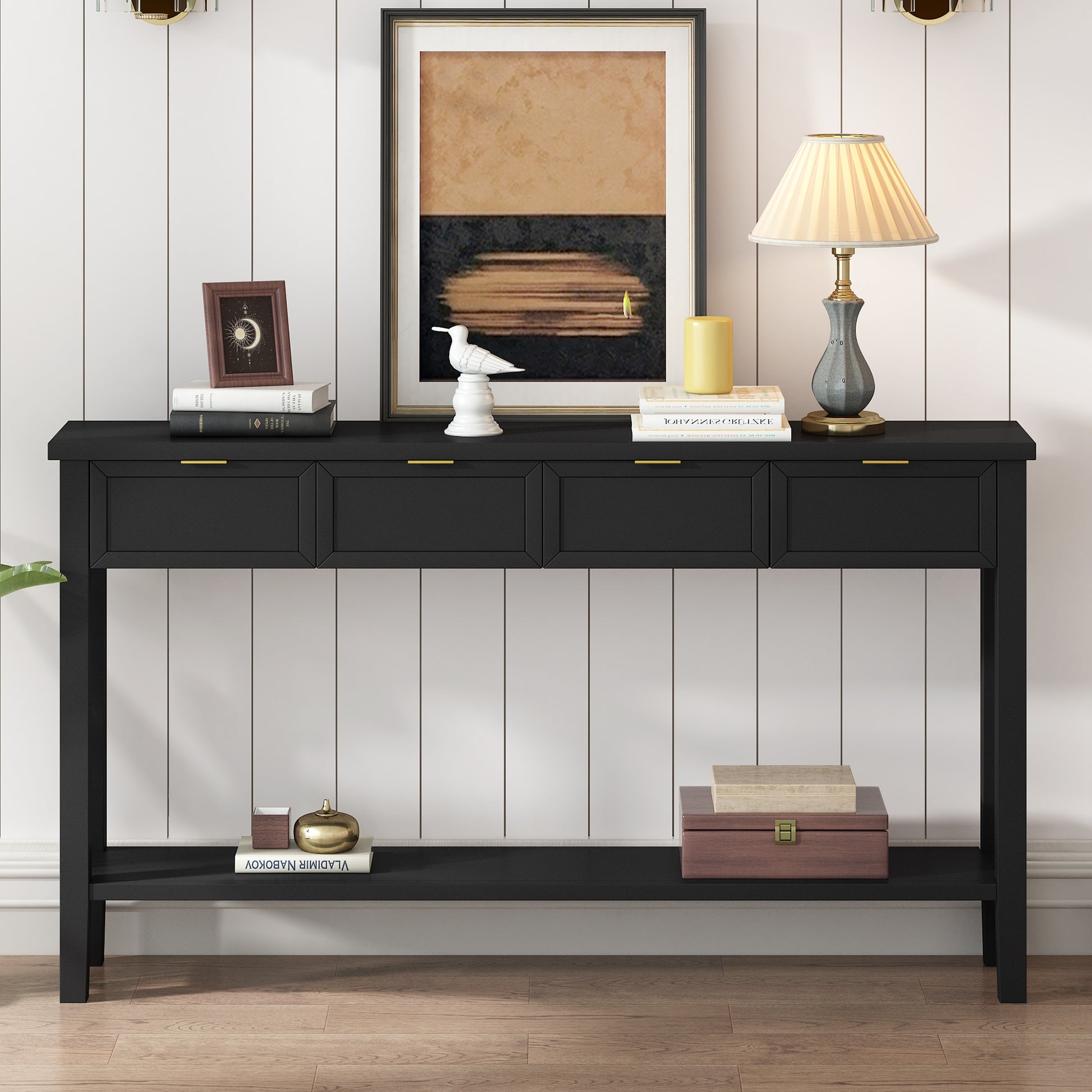 Black console table with four drawers and gold handles