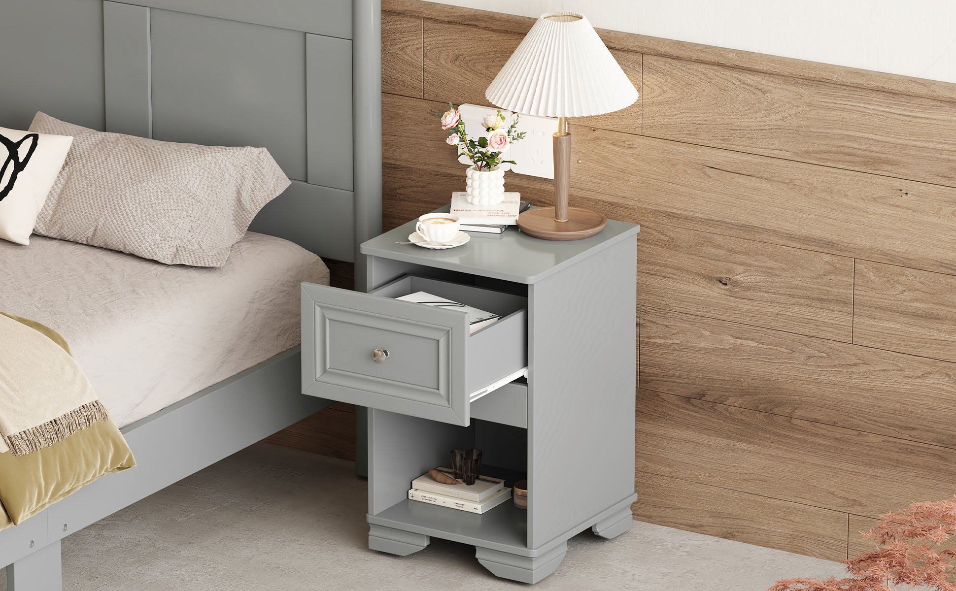 Gray wooden nightstand with open drawer beside a bed