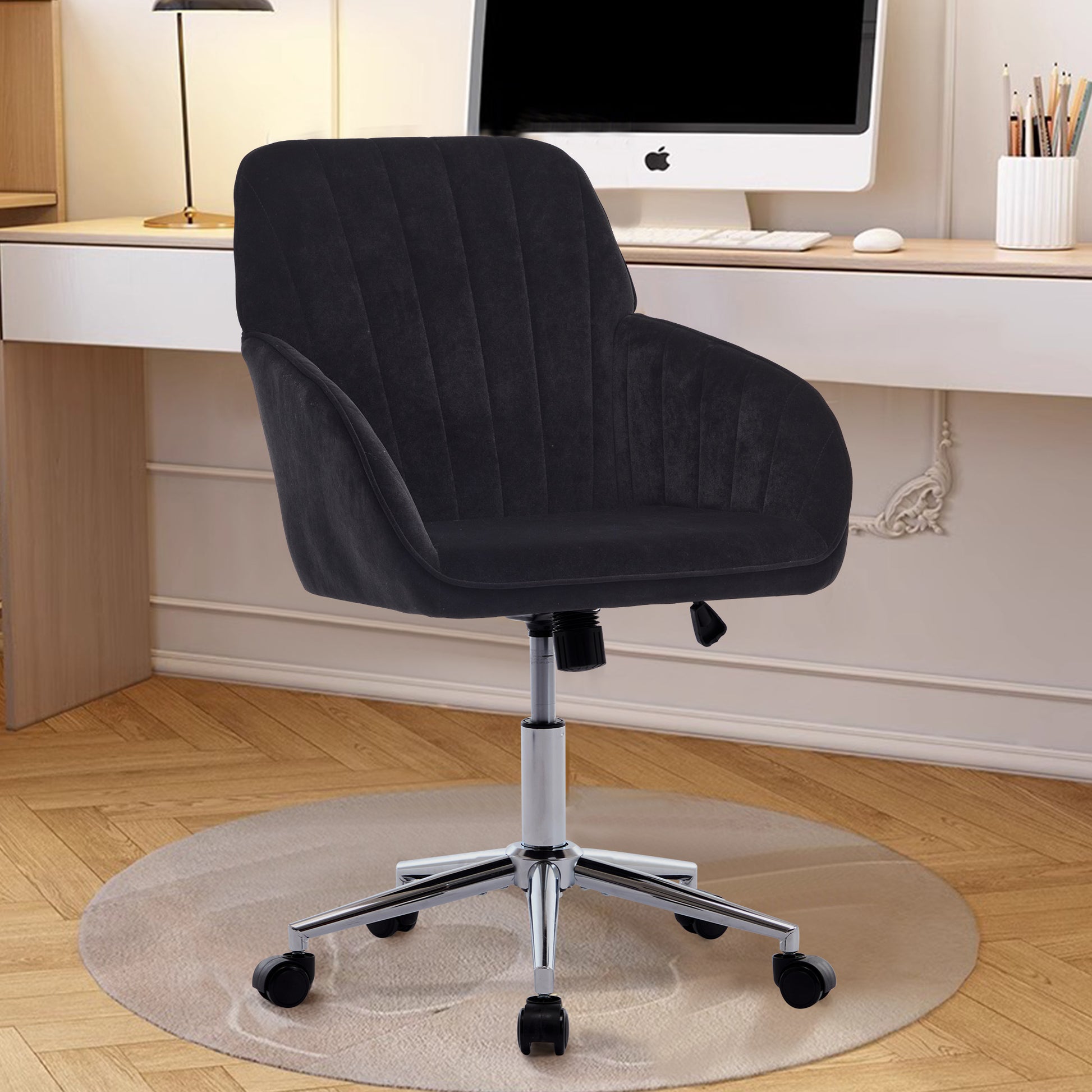 Black velvet desk chair with tufted back and chrome base