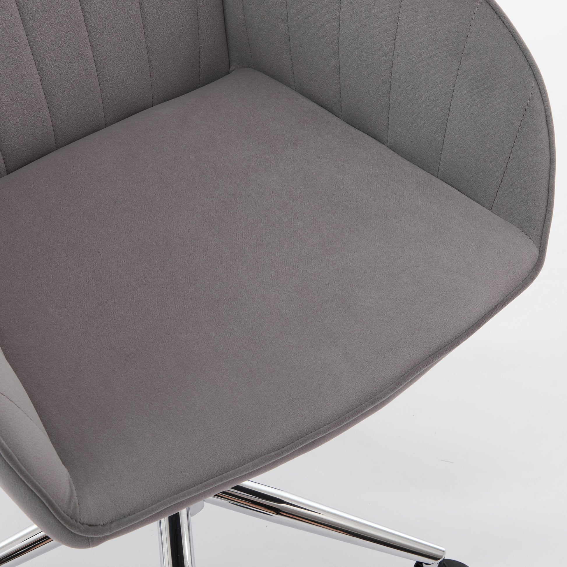 Grey velvet accent chair with tufted back and padded seat for home office