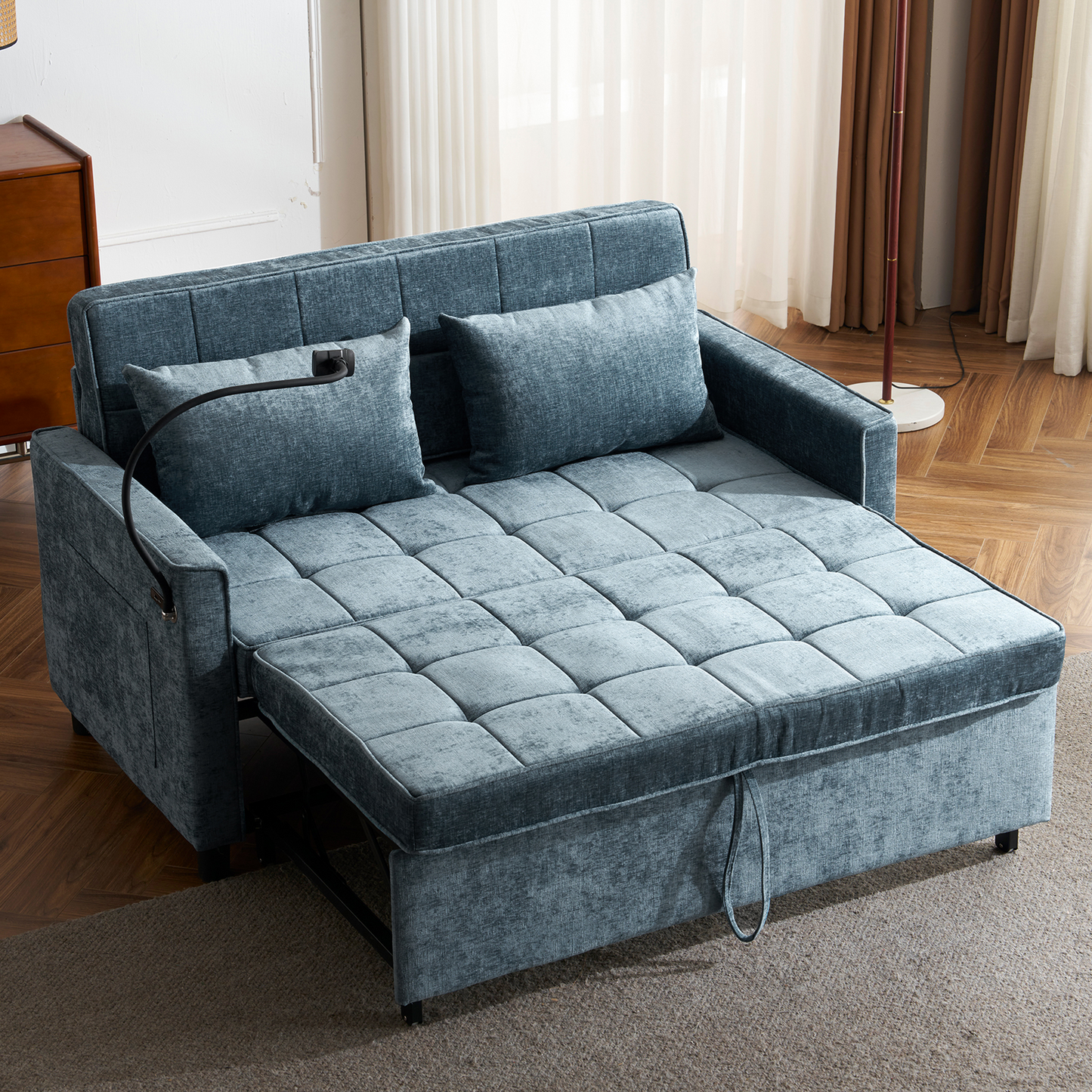 Teal velvet sofa bed with tufted cushions and pullout footrest