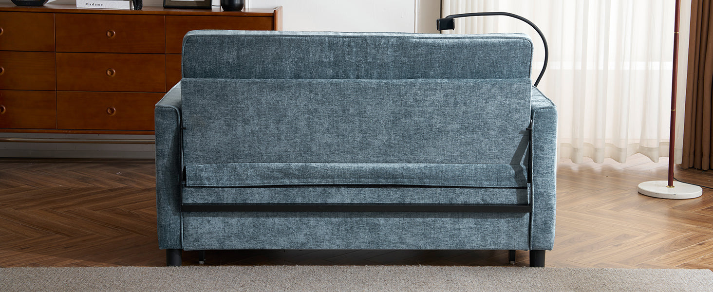 Blue upholstered sofa bed with textured fabric and metal accents