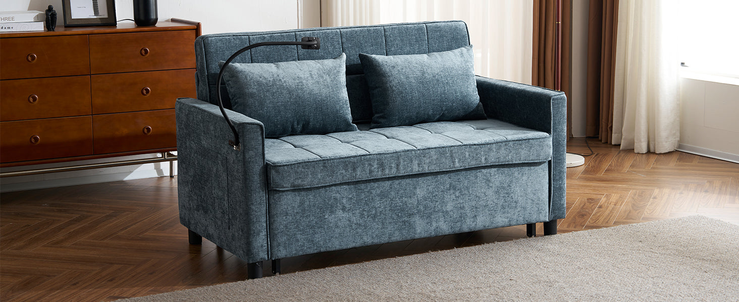 Tufted blue fabric sofa bed with two throw pillows and an adjustable reading lamp