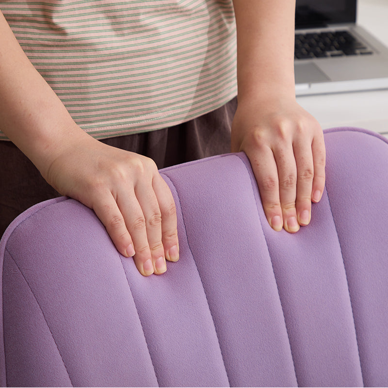 Purple upholstered chair back with plush fabric and supportive stitching