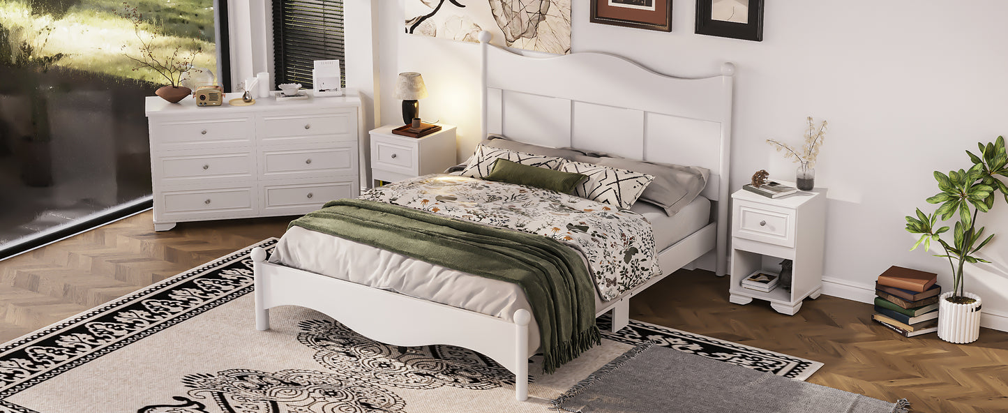 White wooden bed frame with floral bedding and green throw blanket