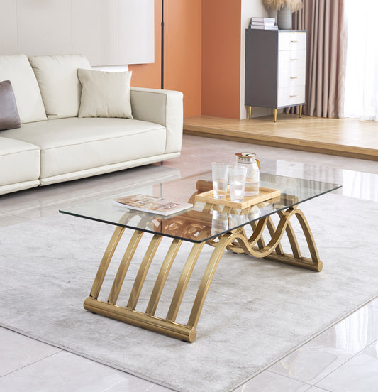 Glass coffee table with curved gold metal legs