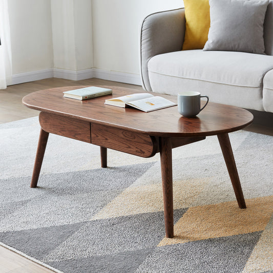 Oval walnut coffee table with two drawers and midcentury modern tapered legs