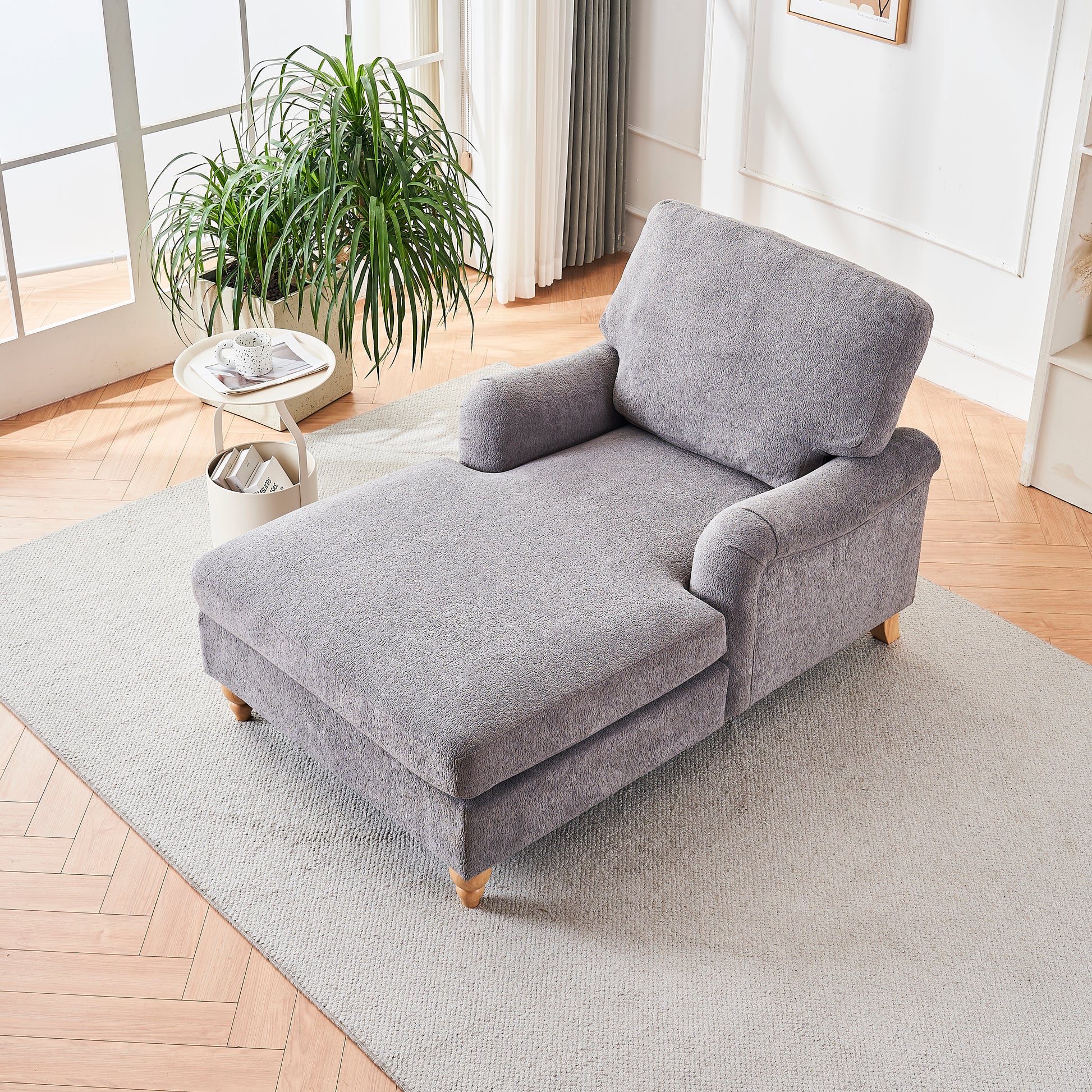 Plush grey fabric chaise lounge with wooden legs