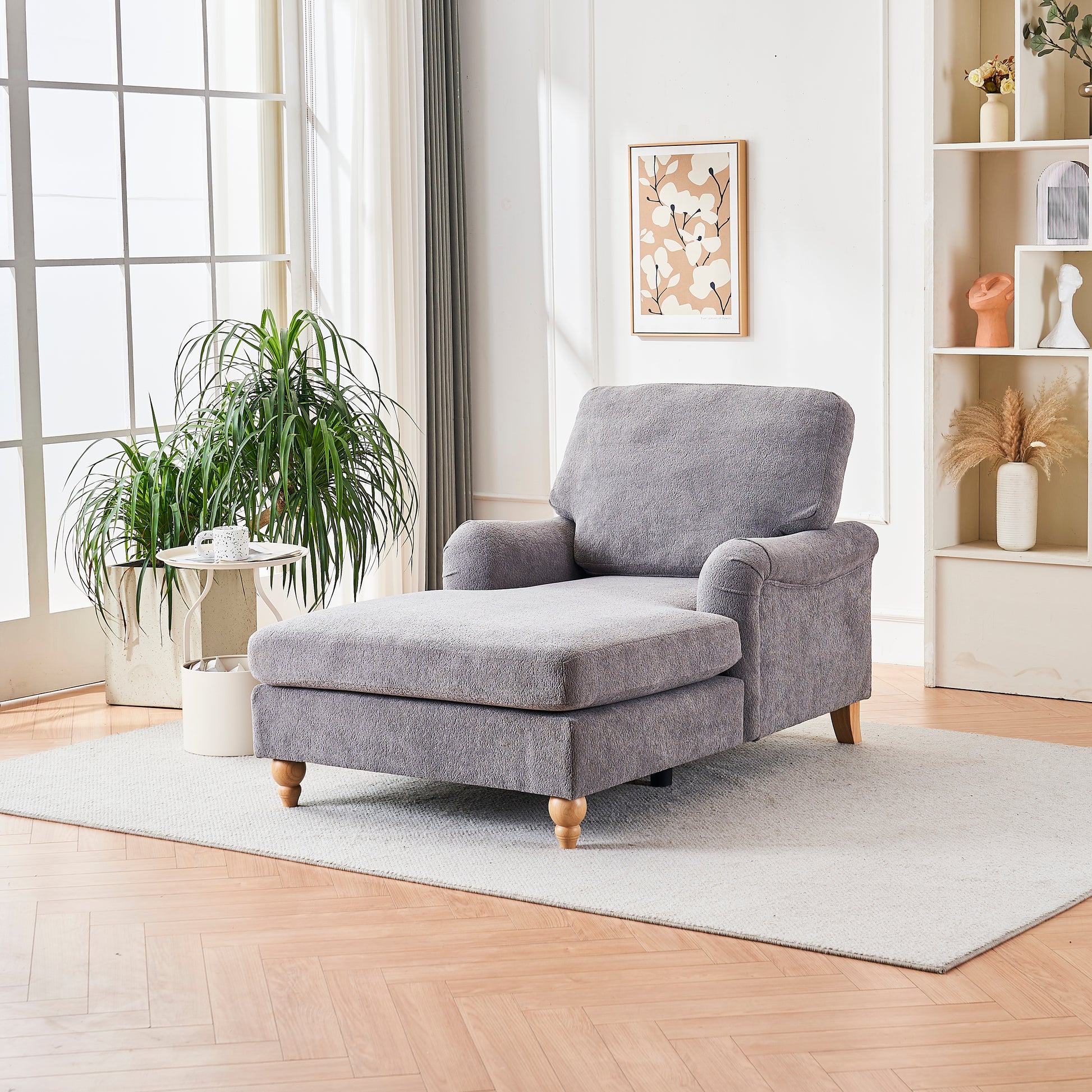 Gray fabric chaise lounge with plush texture and wooden legs