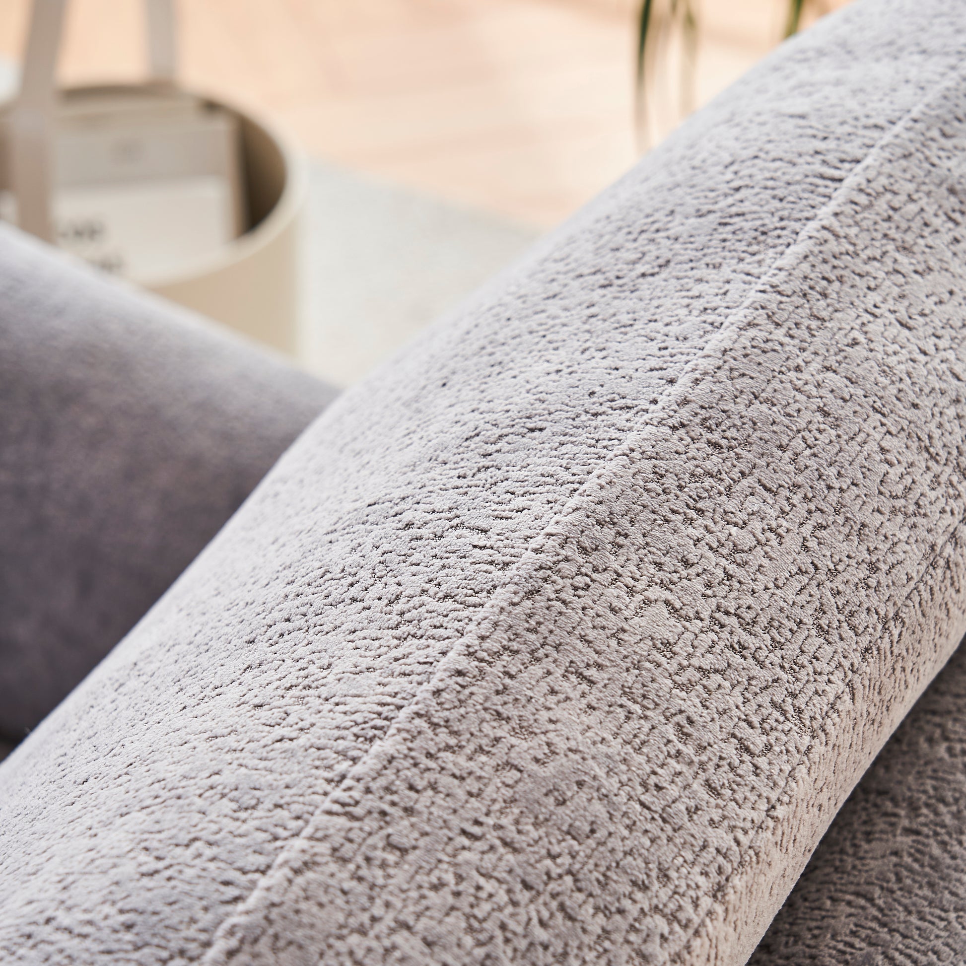 Closeup of a textured grey velvet cushion