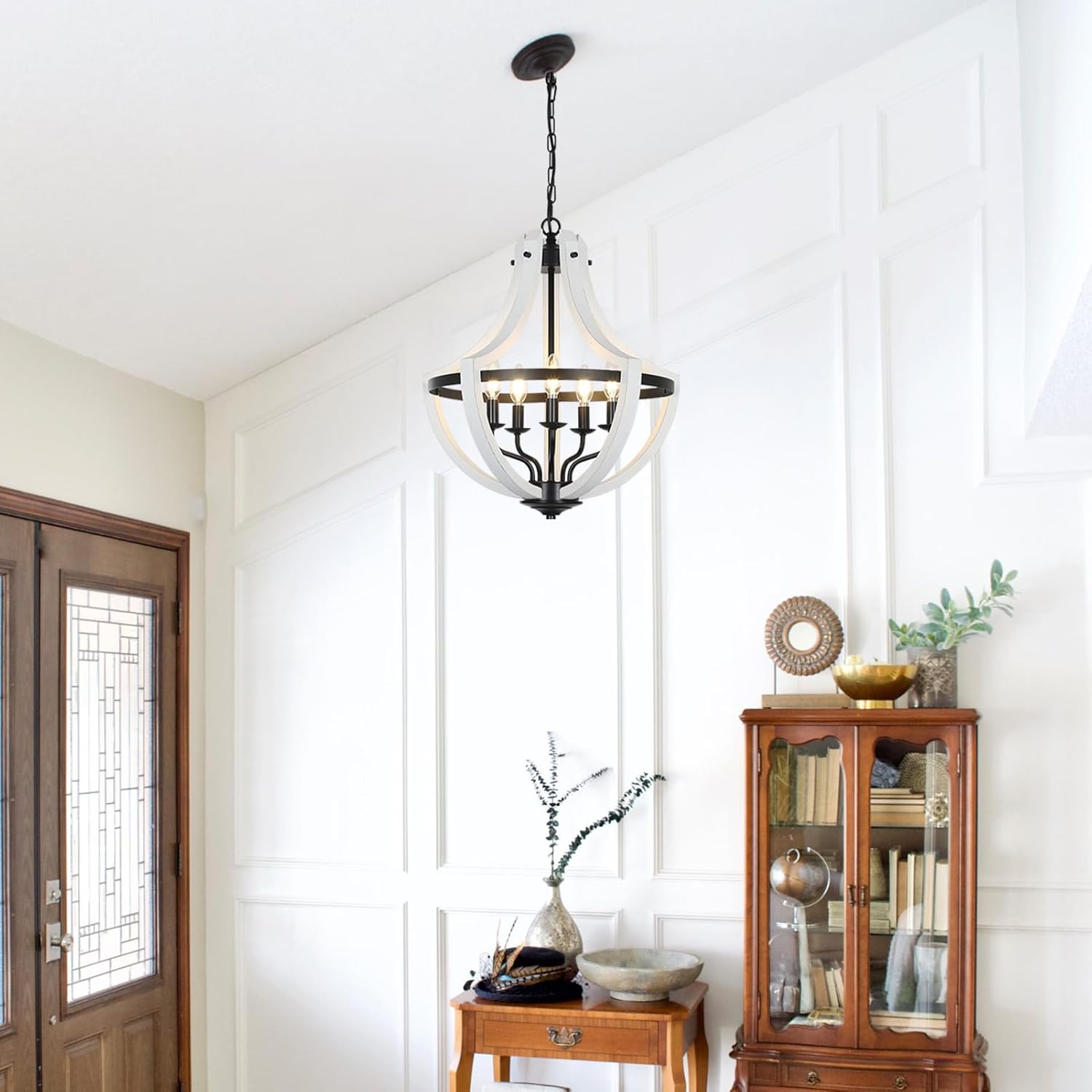 White and black farmhouse chandelier with arched wood panels and wrought iron accents