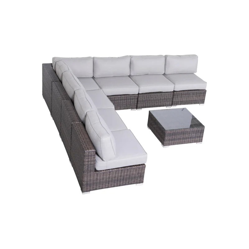Gray sectional patio sofa with wicker base and glasstop coffee table