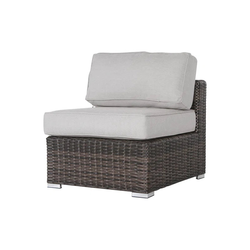Wicker armless chair with light gray cushions and silver feet