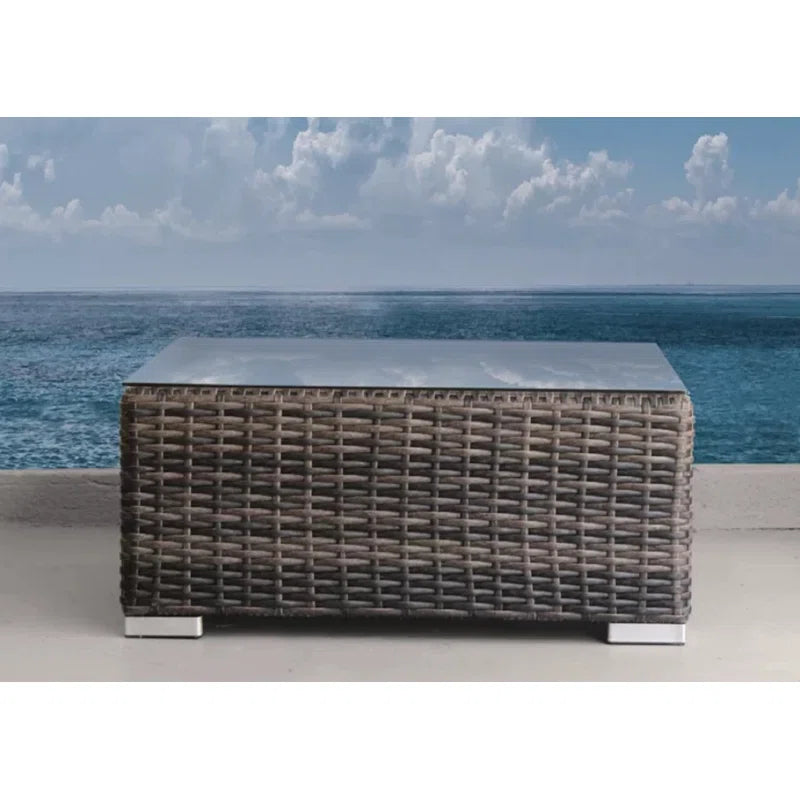 Wicker outdoor coffee table with glass top and brushed nickel legs