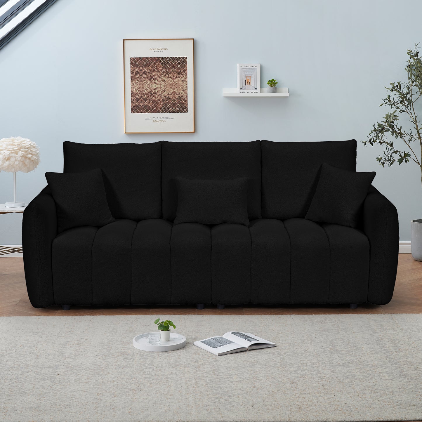 Plush black threeseater sofa with channel tufting and matching throw pillows