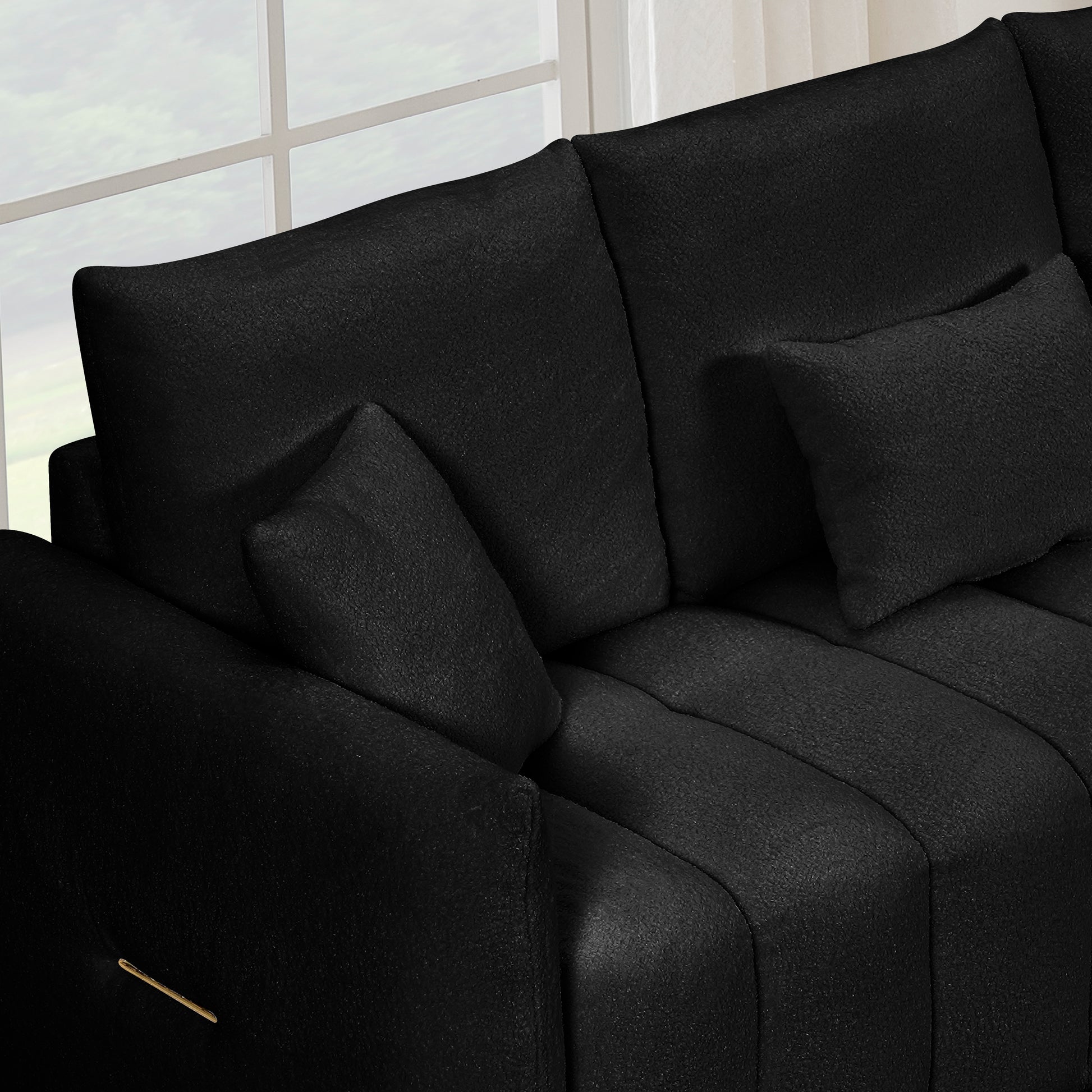 Black velvet sectional sofa with plush cushions