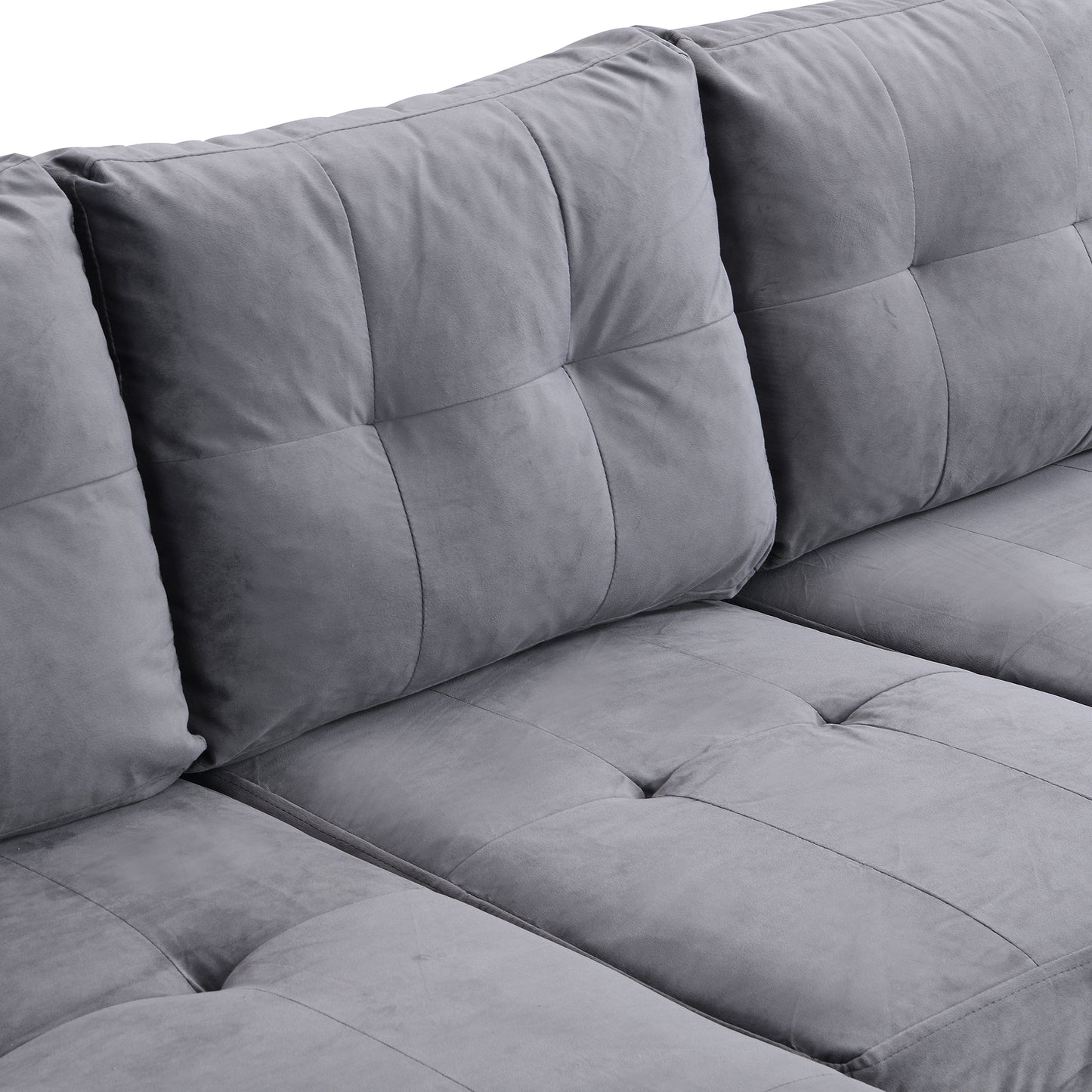 Plush grey velvet sectional sofa with tufted cushions